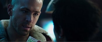 Movie still from “Deadpool” (2016), directed by Tim Miller – A person holding a cup in his hand; Close Up shot, Over the shoulder angle