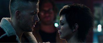 Movie still from “Deadpool” (2016), directed by Tim Miller – A man and a woman face to face in front of a crowd; Close Up shot, Over the shoulder angle