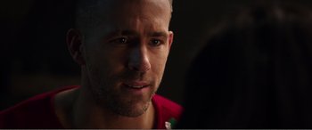 Movie still from “Deadpool” (2016), directed by Tim Miller – A man's face in a dark room; Close Up shot, Over the shoulder angle