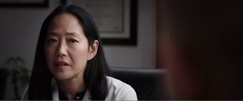 Movie still from “Deadpool” (2016), directed by Tim Miller – A woman sitting in a chair looking at the camera; Close Up shot, Over the shoulder angle