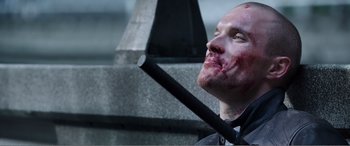 Movie still from “Deadpool” (2016), directed by Tim Miller – A man with blood on his face holding a knife; Close Up shot, Low angle