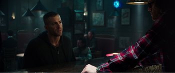 Movie still from “Deadpool” (2016), directed by Tim Miller – A man sitting at a table in front of another man; Medium shot, Over the shoulder angle