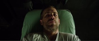 Movie still from “Deadpool” (2016), directed by Tim Miller – A person laying on a bed; Close Up shot, Overhead angle