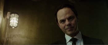 Movie still from “Deadpool” (2016), directed by Tim Miller – A person wearing a suit and tie; Close Up shot, Low angle