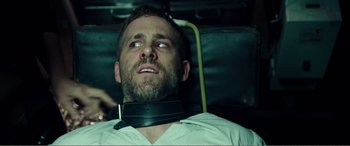 Movie still from “Deadpool” (2016), directed by Tim Miller – A person wearing a neck brace; Close Up shot, Over the shoulder angle