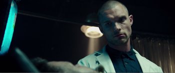 Movie still from “Deadpool” (2016), directed by Tim Miller – A man in a white jacket looking into a mirror; Close Up shot, Low angle