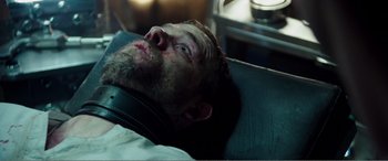 Movie still from “Deadpool” (2016), directed by Tim Miller – A man with a beard is laying in a hospital bed; Close Up shot, Over the shoulder angle