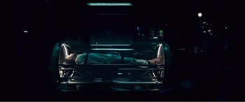 Movie still from “Deadpool” (2016), directed by Tim Miller – A man laying on a bed in a dark room; Wide shot, Overhead angle