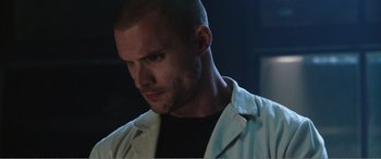 Movie still from “Deadpool” (2016), directed by Tim Miller – A person wearing a white jacket; Close Up shot, Low angle