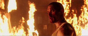 Movie still from “Deadpool” (2016), directed by Tim Miller – A person with a fire in the background; Close Up shot, Low angle