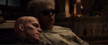 Movie still from “Deadpool” (2016), directed by Tim Miller – A man and a woman sitting next to each other on a couch; Close Up shot, Low angle