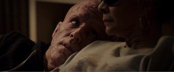 Movie still from “Deadpool” (2016), directed by Tim Miller – An old man and a young woman looking at each other; Close Up shot, High angle