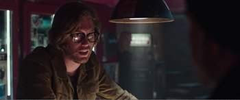 Movie still from “Deadpool” (2016), directed by Tim Miller – A man with glasses sitting in front of a lamp; Close Up shot, Low angle