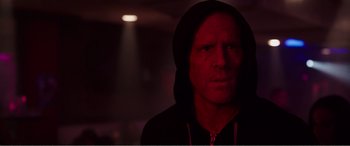 Movie still from “Deadpool” (2016), directed by Tim Miller – A man in a black hooded sweatshirt is in a dark room; Close Up shot, Low angle