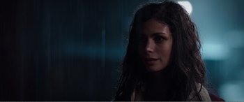 Movie still from “Deadpool” (2016), directed by Tim Miller – A person with long dark hair; Close Up shot, Over the shoulder angle