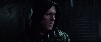 Movie still from “Deadpool” (2016), directed by Tim Miller – A person wearing a hooded jacket; Close Up shot, Low angle