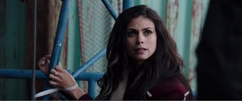 Movie still from “Deadpool” (2016), directed by Tim Miller – A person with long dark hair; Close Up shot, Over the shoulder angle