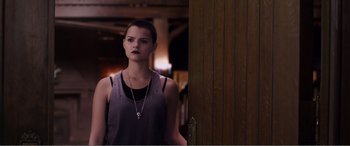 Movie still from “Deadpool” (2016), directed by Tim Miller – A woman standing in front of a wooden door; Medium shot, Over the shoulder angle