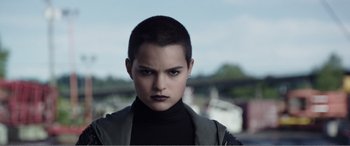 Movie still from “Deadpool” (2016), directed by Tim Miller – A person with short black hair; Close Up shot, Low angle