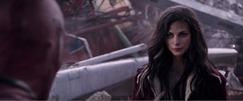 Movie still from “Deadpool” (2016), directed by Tim Miller – A woman standing in front of a rusted structure; Close Up shot, Over the shoulder angle
