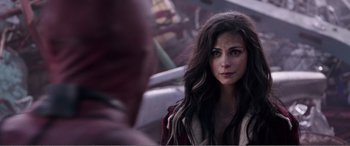 Movie still from “Deadpool” (2016), directed by Tim Miller – A person with long black hair; Close Up shot, Over the shoulder angle