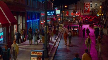 Movie still from “The Firm” (1993), directed by Sydney Pollack – A group of people walking down a street at night; Extreme Wide shot, High angle
