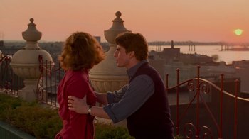 Movie still from “The Firm” (1993), directed by Sydney Pollack – A man and a woman standing next to each other on top of a building; Medium shot, Over the shoulder angle