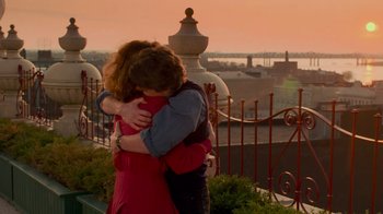 Two people hugging each other on a balcony