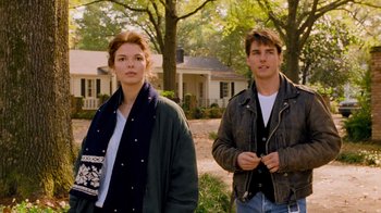 Movie still from “The Firm” (1993), directed by Sydney Pollack – A man and a woman standing next to each other in front of a house; Medium shot, Over the shoulder angle
