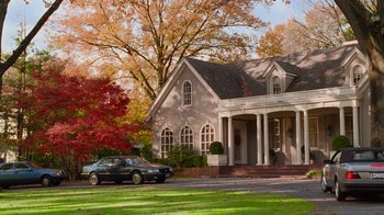 Movie still from “The Firm” (1993), directed by Sydney Pollack – A car is parked in front of a large house; Extreme Wide shot, High angle