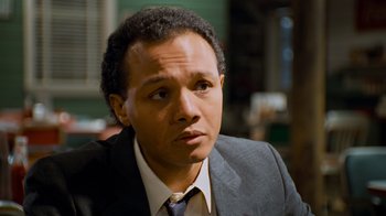 Movie still from “The Firm” (1993), directed by Sydney Pollack – A person wearing a suit and tie; Close Up shot, Low angle