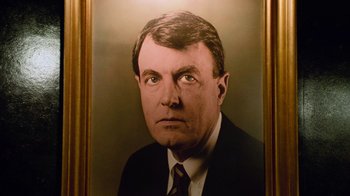 Movie still from “The Firm” (1993), directed by Sydney Pollack – A portrait of a man in a suit and tie; Extreme Close Up shot, High angle