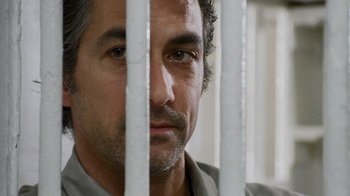 Movie still from “The Firm” (1993), directed by Sydney Pollack – A person behind a fence; Close Up shot, Low angle