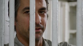 Movie still from “The Firm” (1993), directed by Sydney Pollack – A person behind a fence; Close Up shot, Over the shoulder angle