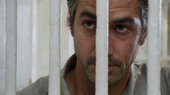 Movie still from “The Firm” (1993), directed by Sydney Pollack – A person behind a fence; Close Up shot, Overhead angle