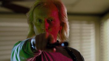 Movie still from “The Firm” (1993), directed by Sydney Pollack – A man with blonde long hair pointing at the camera; Close Up shot, Low angle