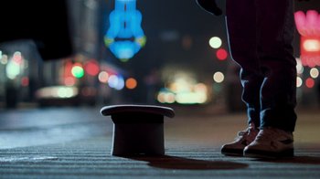 Movie still from “The Firm” (1993), directed by Sydney Pollack – A man standing next to a top hat; Extreme Close Up shot, Low angle