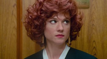 Movie still from “The Firm” (1993), directed by Sydney Pollack – A person with red curly hair; Close Up shot, High angle