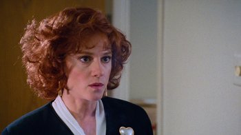 Movie still from “The Firm” (1993), directed by Sydney Pollack – A person wearing a suit and tie; Close Up shot, Over the shoulder angle