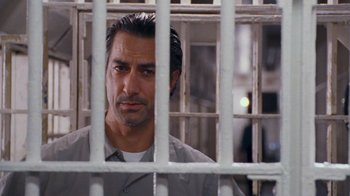 Movie still from “The Firm” (1993), directed by Sydney Pollack – A person behind a fence; Close Up shot, Low angle