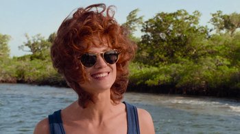 Movie still from “The Firm” (1993), directed by Sydney Pollack – A person wearing sunglasses near a body of water; Close Up shot, Over the shoulder angle