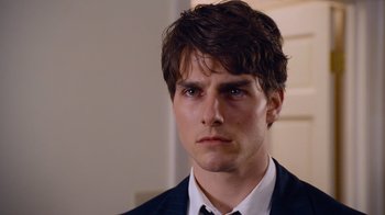 Movie still from “The Firm” (1993), directed by Sydney Pollack – A person wearing a suit and tie; Close Up shot, Over the shoulder angle