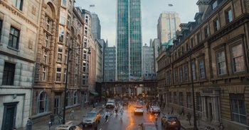 Movie still from “The Flash” (2023), directed by Andy Muschietti – A busy city street with cars and people on the sidewalk; Extreme Wide shot, Low angle