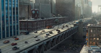 Movie still from “The Flash” (2023), directed by Andy Muschietti – An aerial view of a busy city street with cars on a bridge; Extreme Wide shot, High angle