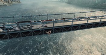 Movie still from “The Flash” (2023), directed by Andy Muschietti – A person jumping off a bridge into the ocean; Extreme Wide shot, Overhead angle