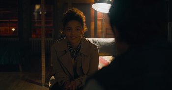 Movie still from “The Flash” (2023), directed by Andy Muschietti – A woman sitting on a couch in front of a man; Medium shot, Over the shoulder angle