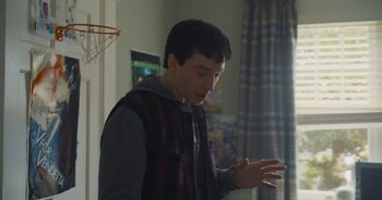 Movie still from “The Flash” (2023), directed by Andy Muschietti – A man standing in a room with his hands outstreched; Medium shot, Low angle