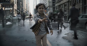 Movie still from “The Flash” (2023), directed by Andy Muschietti – A young girl is walking down the street in the rain; Medium shot, High angle