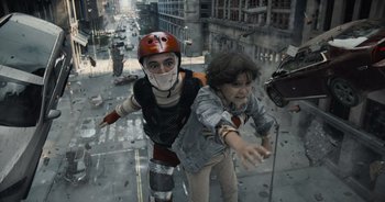 Movie still from “The Flash” (2023), directed by Andy Muschietti – Two people in costume are in the middle of a street; Wide shot, Low angle