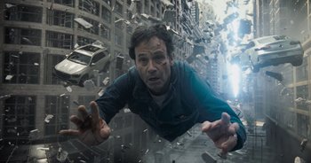 Movie still from “The Flash” (2023), directed by Andy Muschietti – A man is falling through the air in a city; Medium shot, Overhead angle